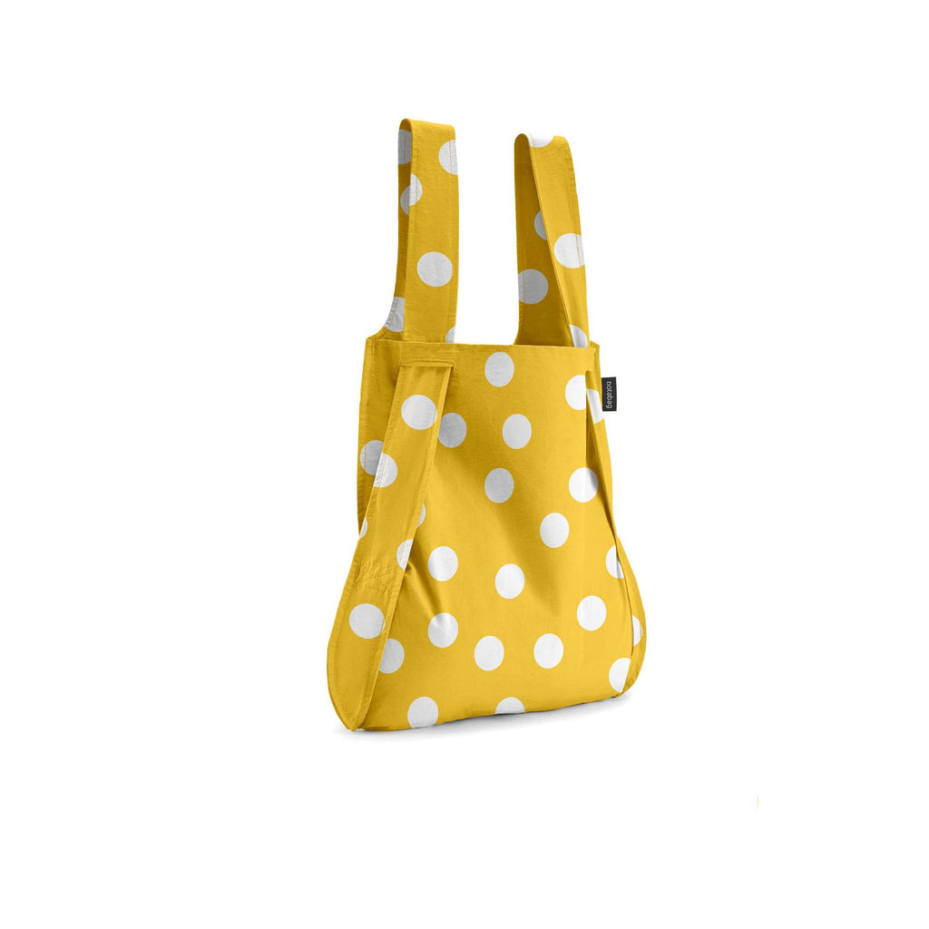Yellow bag with white polka dots on a white background