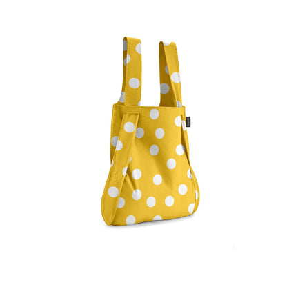 Yellow bag with white polka dots on a white background