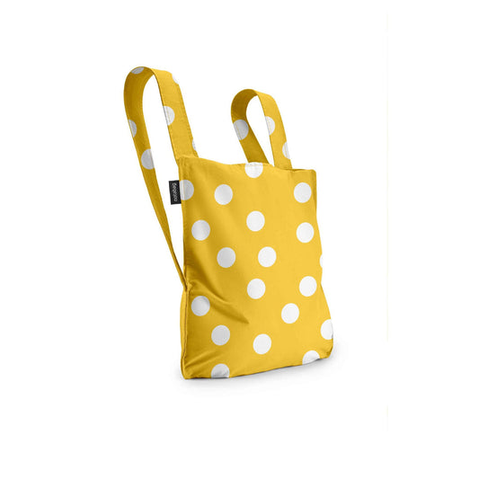 Yellow tote bag with white polka dots on a white background