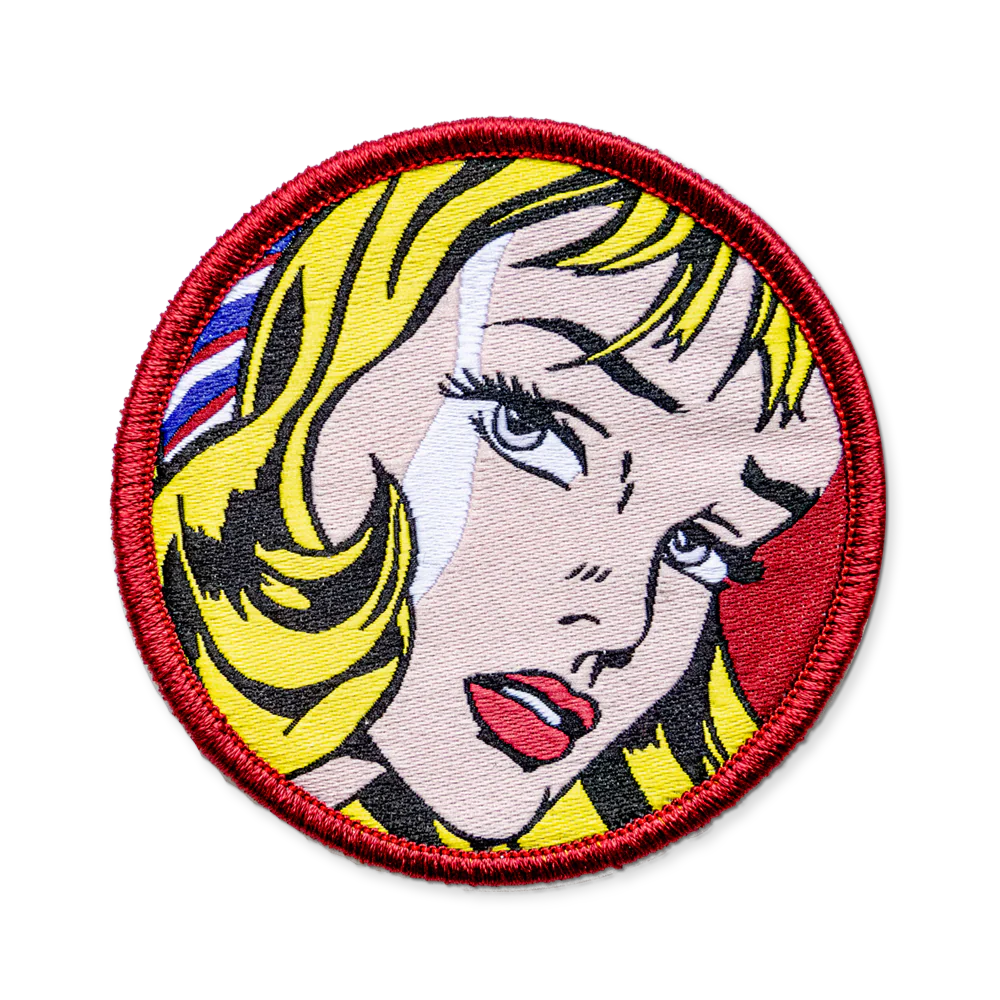 Circular patch with a stylized face design on a white background