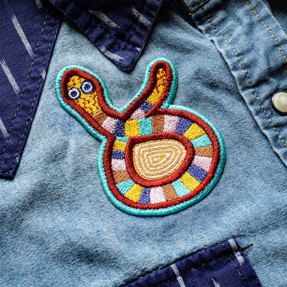 Colorful embroidered patch on a denim jacket