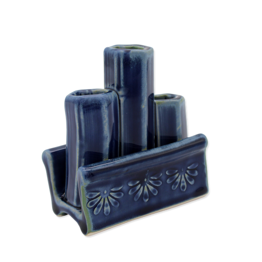 Blue ceramic vase holder with three cylindrical compartments on a white background