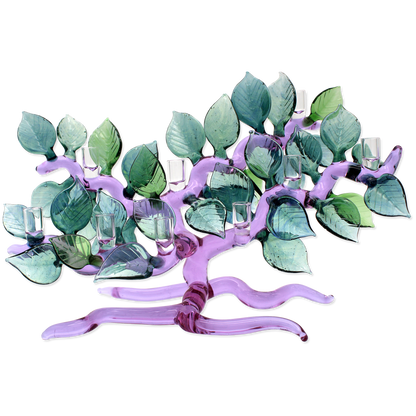 Decorative Menorah shaped like a tree with green leaves and purple branches on a white background