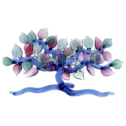 Decorative candle holder with colorful leaf-like designs on a white background