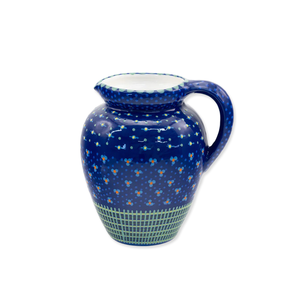 Ceramic pitcher with blue floral pattern on a white background