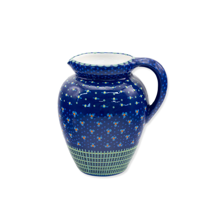 Ceramic pitcher with blue floral pattern on a white background