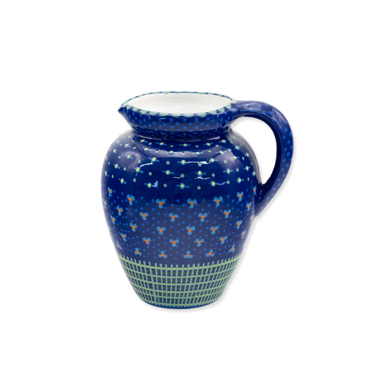 Ceramic pitcher with blue floral pattern on a white background