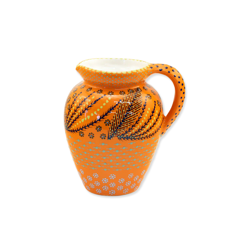Decorative ceramic pitcher with orange and black patterns on a white background