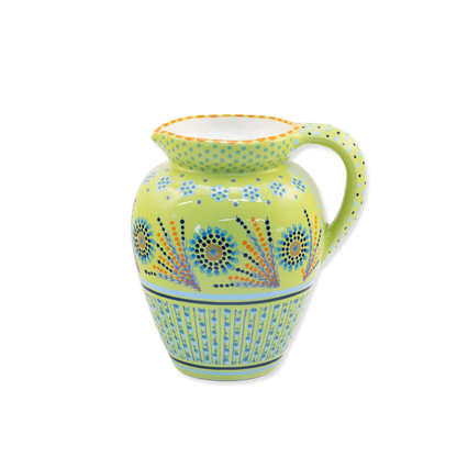 Decorative ceramic pitcher with floral patterns on a white background