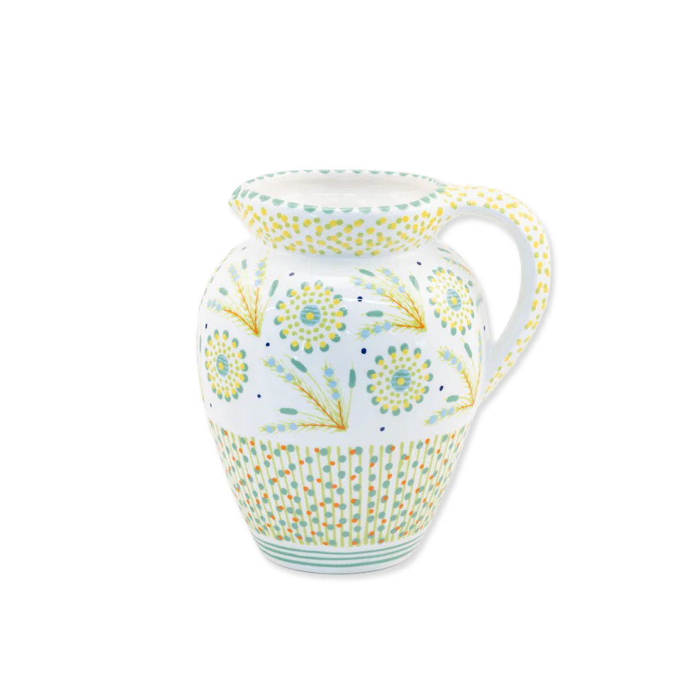 Decorative ceramic pitcher with floral patterns on a white background