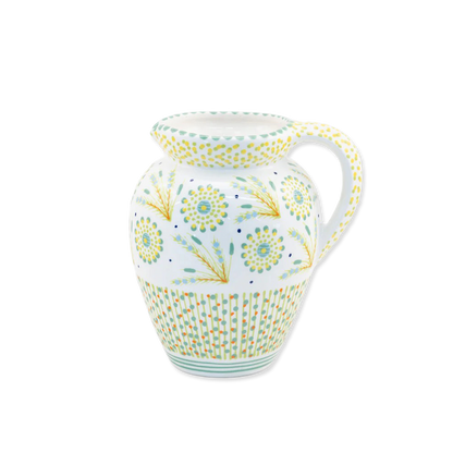 Decorative ceramic pitcher with floral patterns on a white background