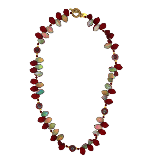 Necklace with red iridescent leaf beads on a white background