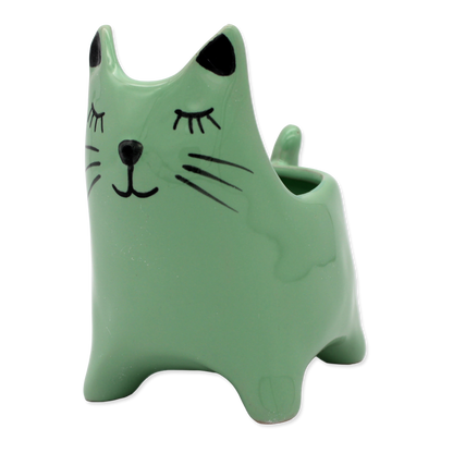 Green cat-shaped vase with black accents on a white background