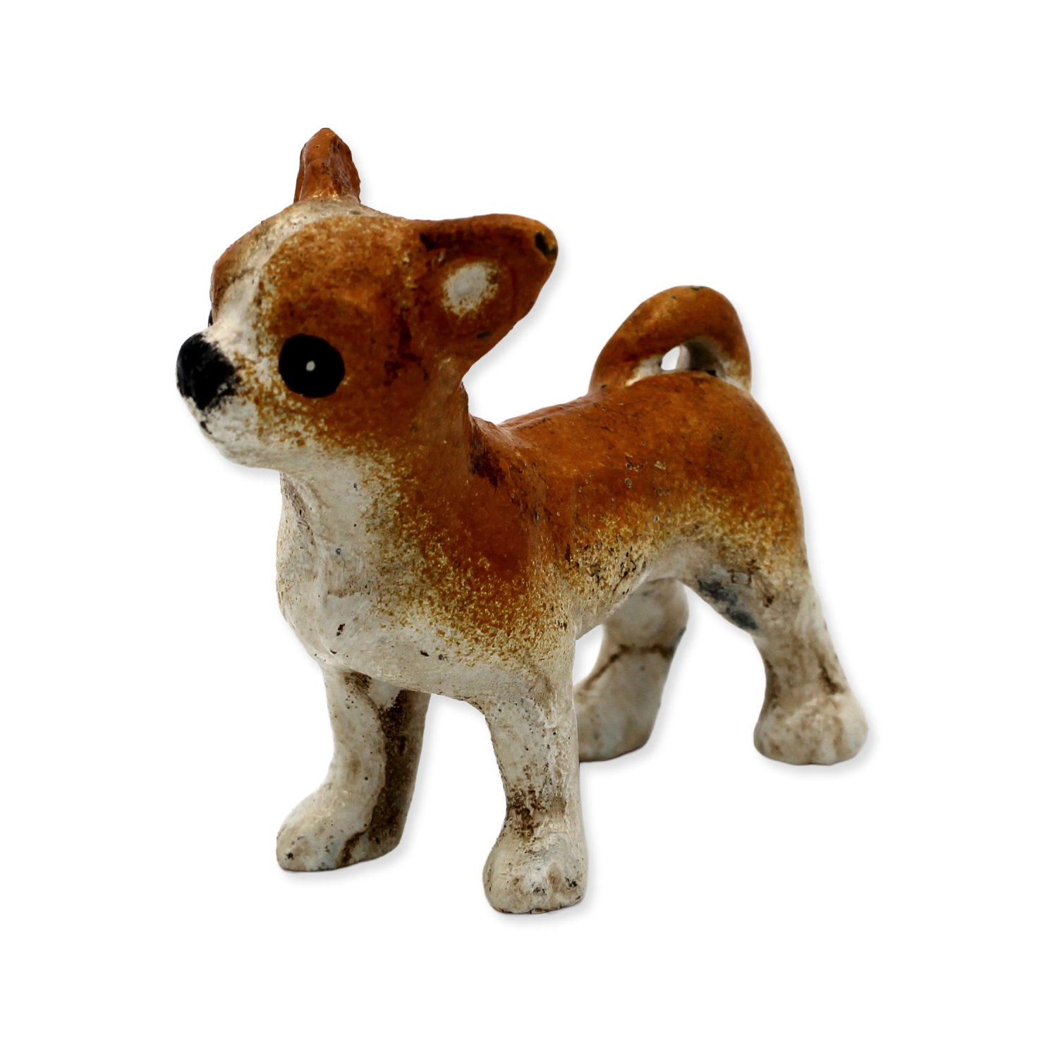 Small brown and white dog figurine on a white background