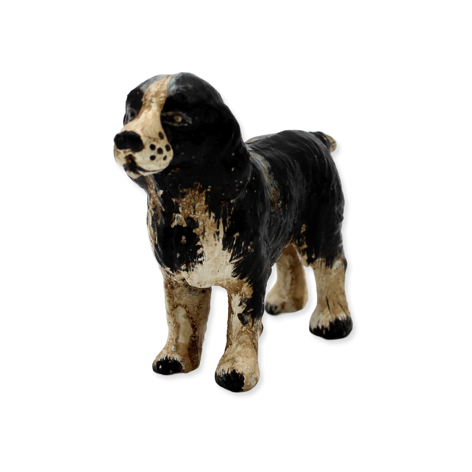 Vintage-style cast iron dog with black and brown coloring on a white background