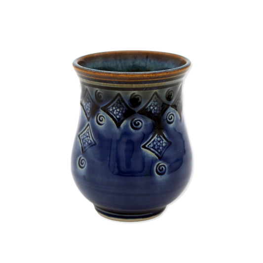 Blue ceramic vase with decorative patterns on a white background