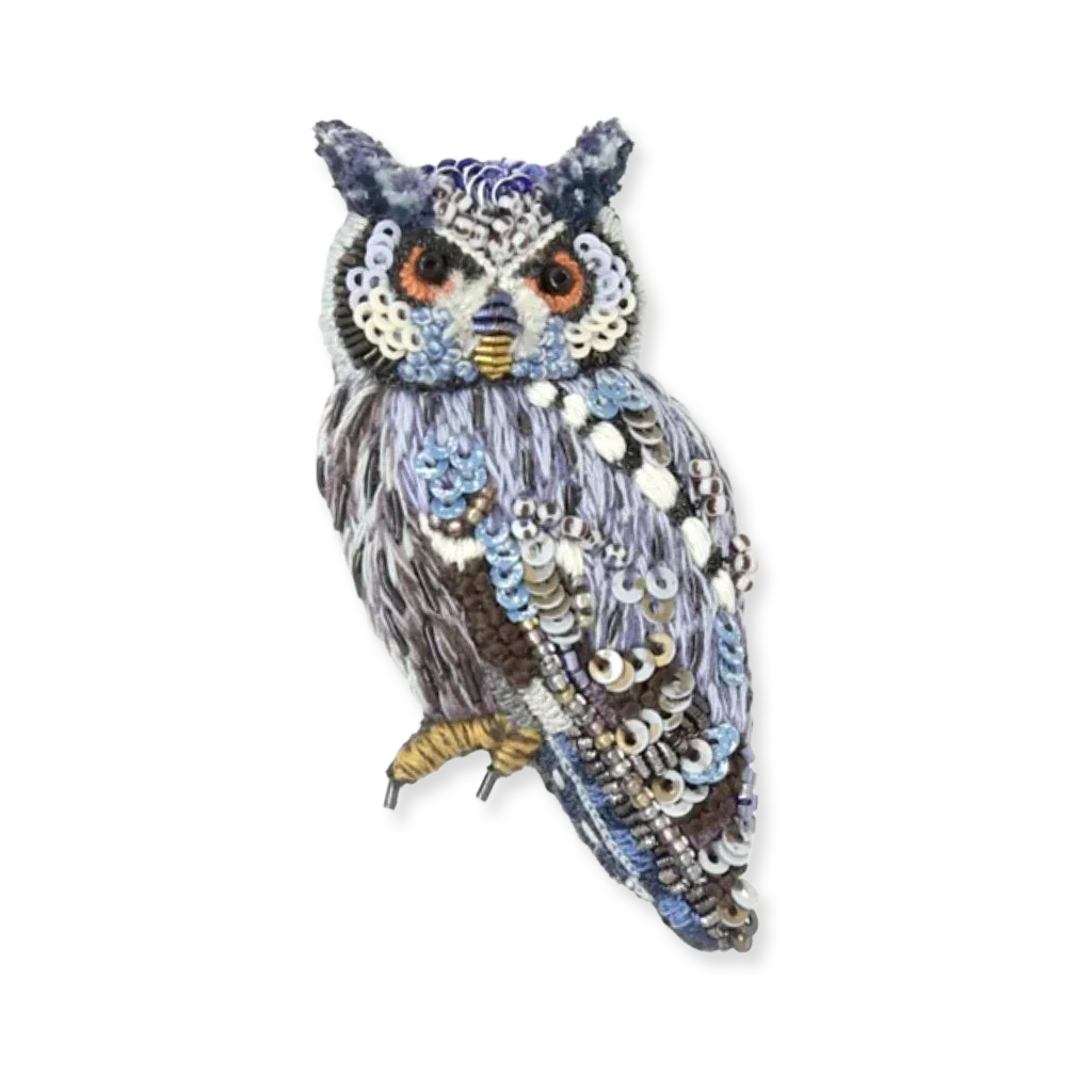 Decorative owl with sequins on a white background