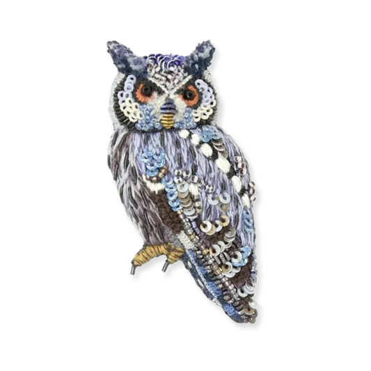 Decorative owl with sequins on a white background