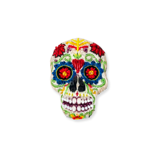 Colorful sugar skull decoration on a white background