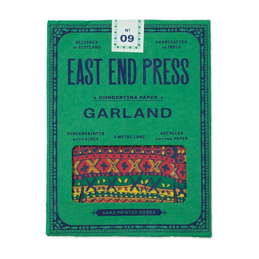 Green packaging of East End Press Garland with colorful patterned paper inside