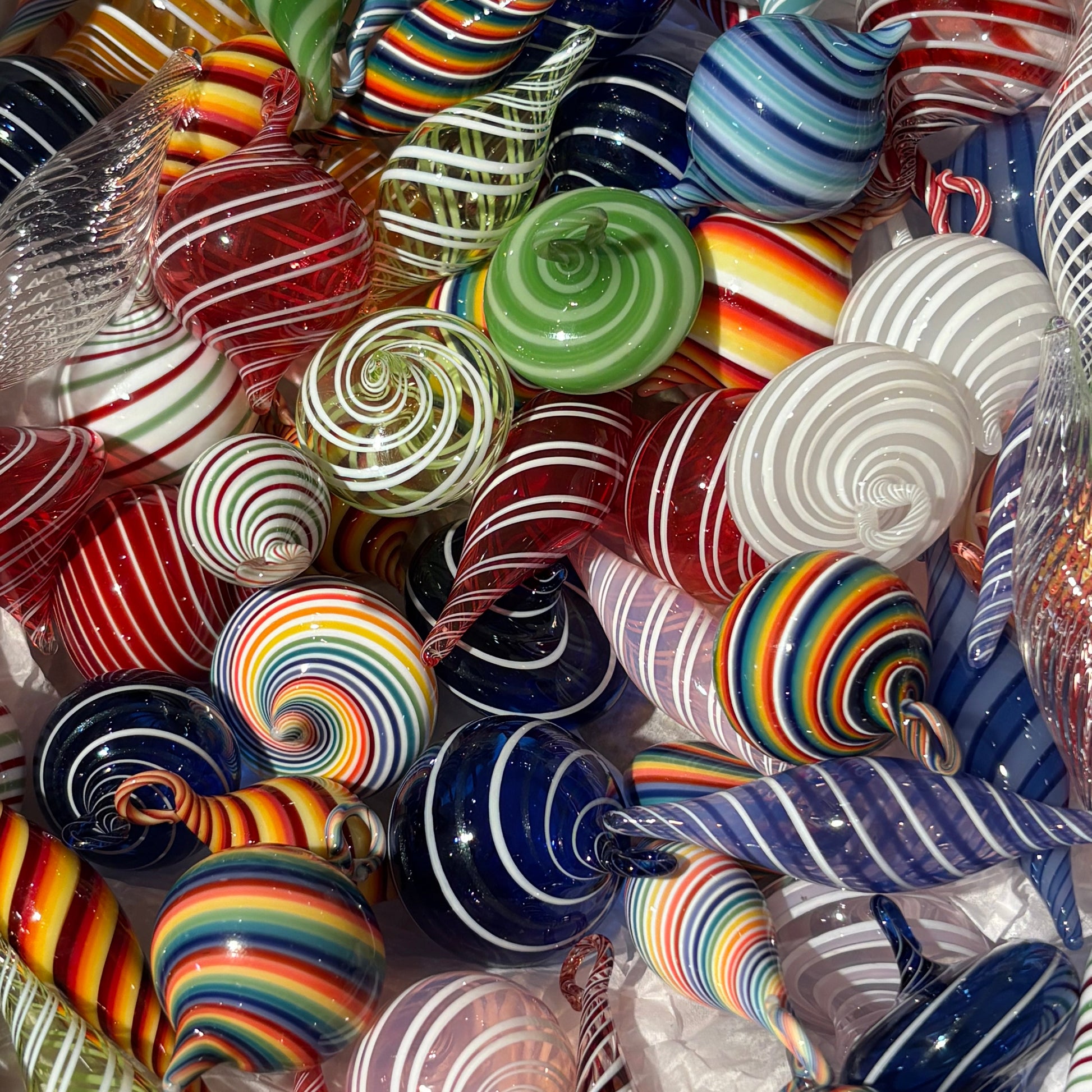 Colorful glass swirl ornaments in a clear container