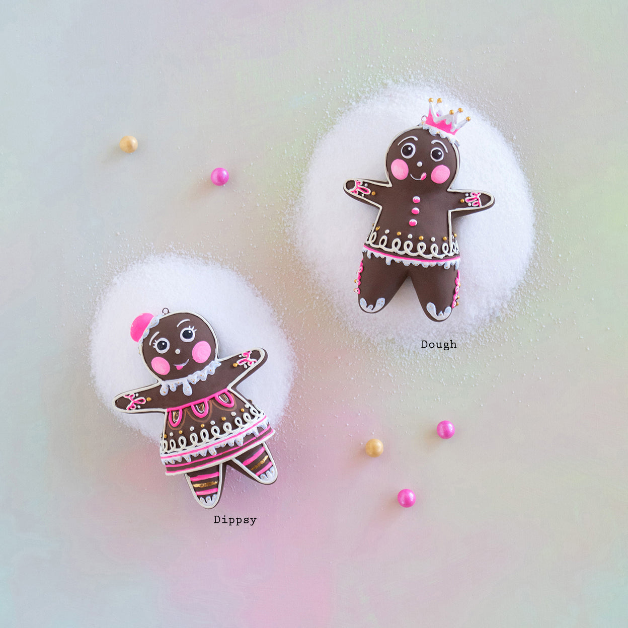 Two gingerbread figurines on a colorful gradient background