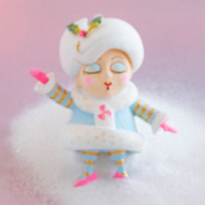 Cartoon character with a white hat and blue outfit on a pink background