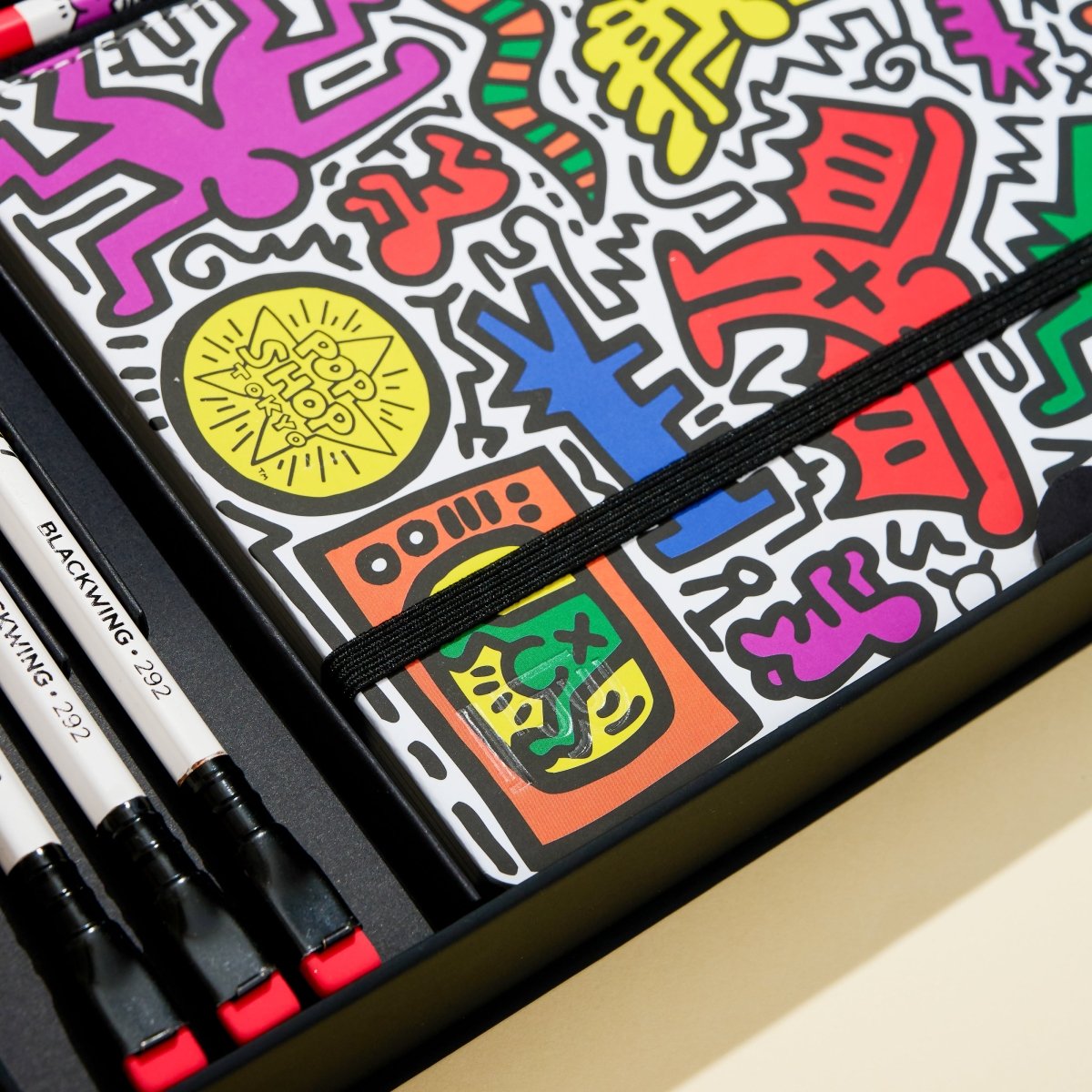 Colorful art set with markers and a design on a black background