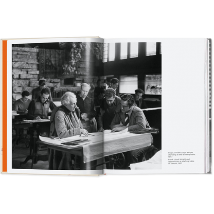 Open book showing a black and white photograph of a group of people in a classroom setting.