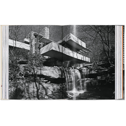 Open book showing a black and white photograph of a modern building integrated with nature.