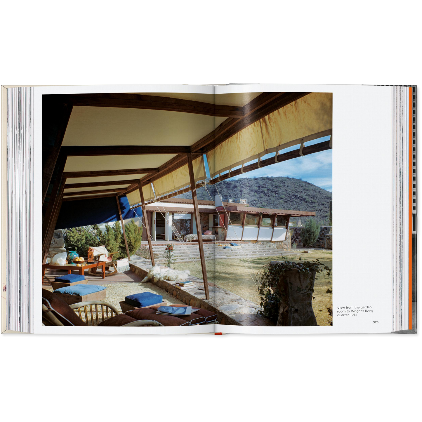 Open book showing a photograph of a modern outdoor living space with mountains in the background.