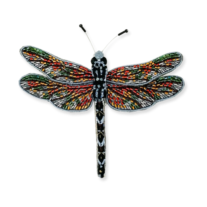 Colorful dragonfly-shaped brooch on a white background