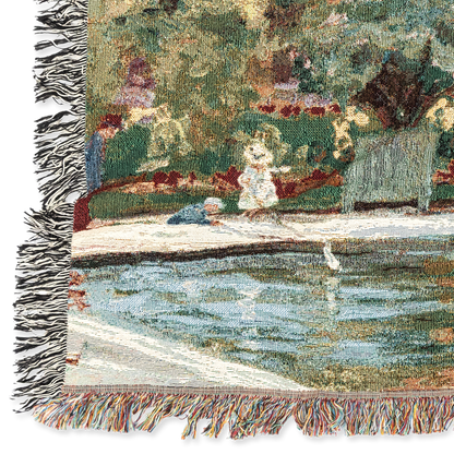 Woven blanket with a scenic design of a dock and figures, featuring fringes on the edges.