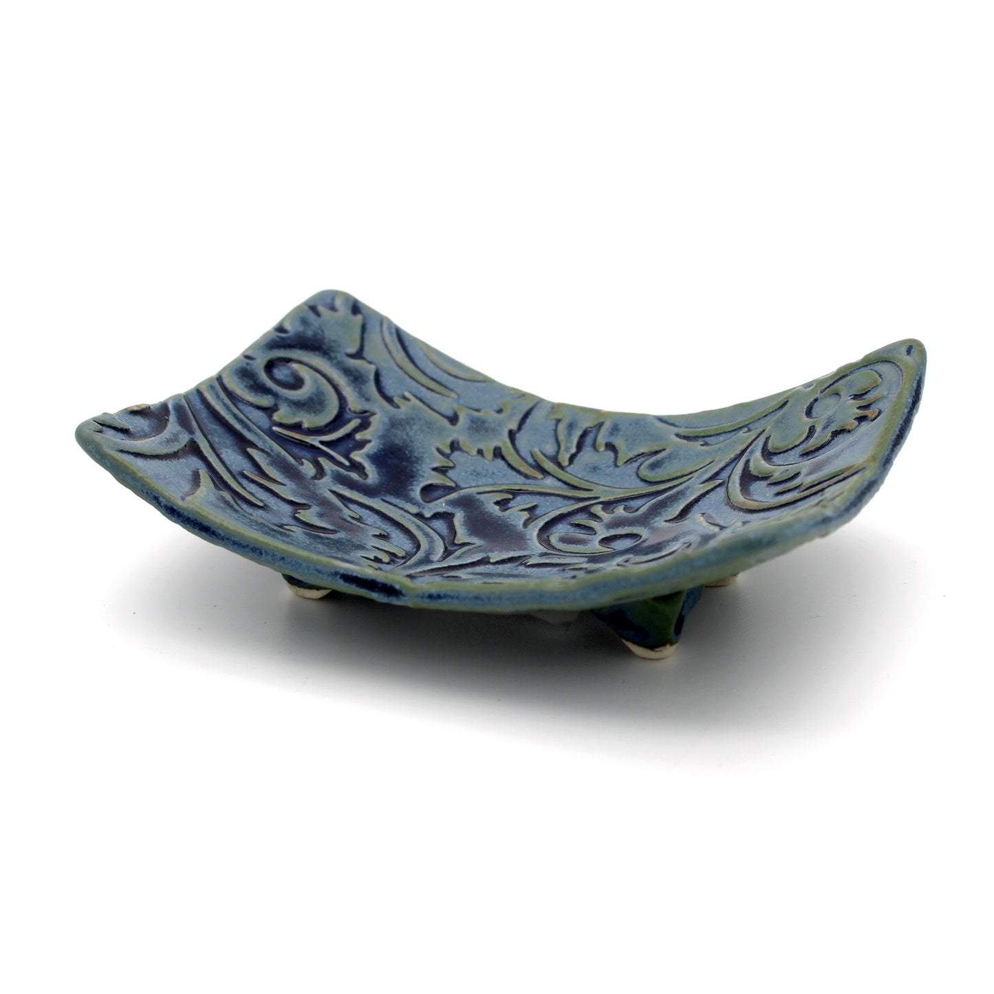 Blue ceramic dish with intricate patterns on a white background