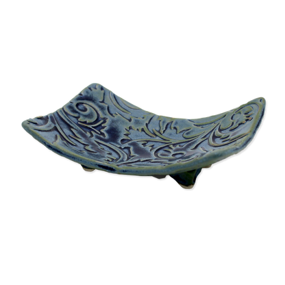 Decorative blue ceramic soap dish with intricate patterns on a white background