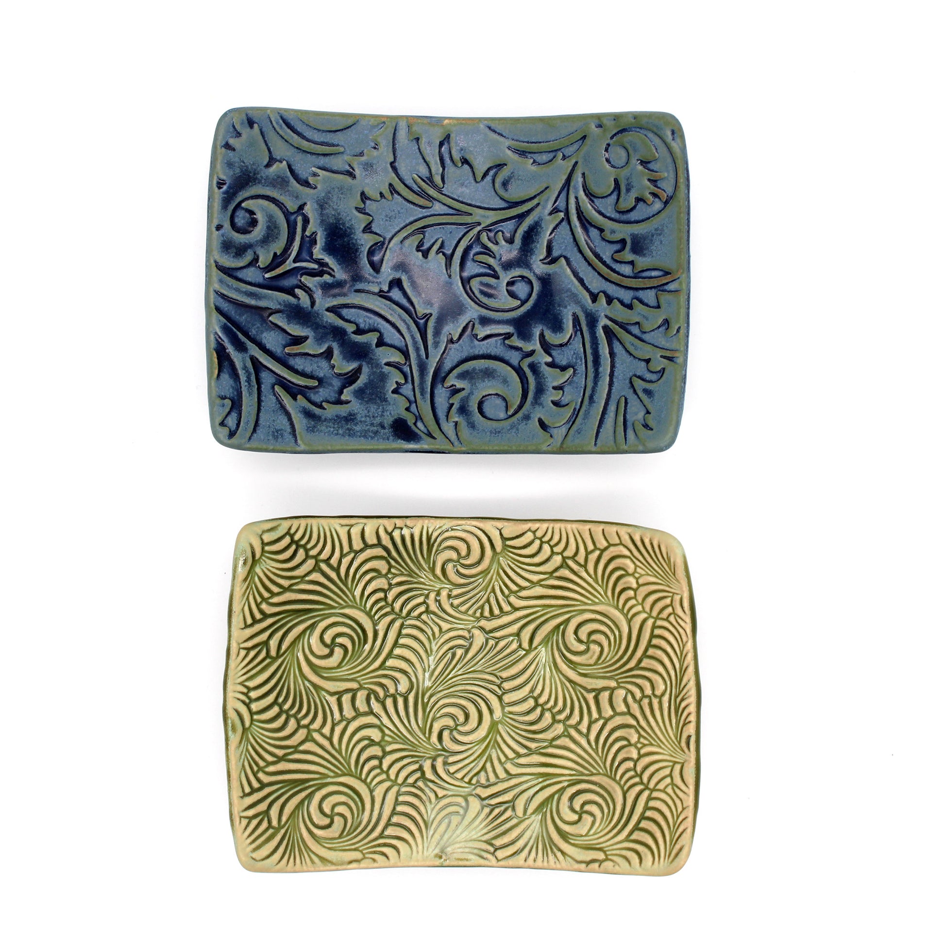 Two rectangular ceramic dishes with decorative patterns on a white background