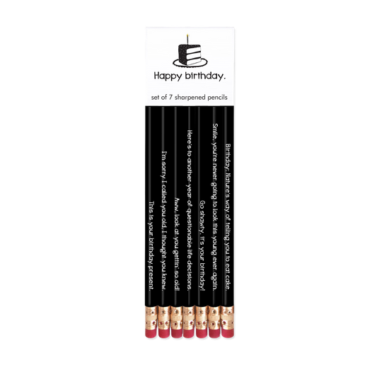 Set of 7 sharpened pencils with humorous text in a packaging labeled 'Happy Birthday'.