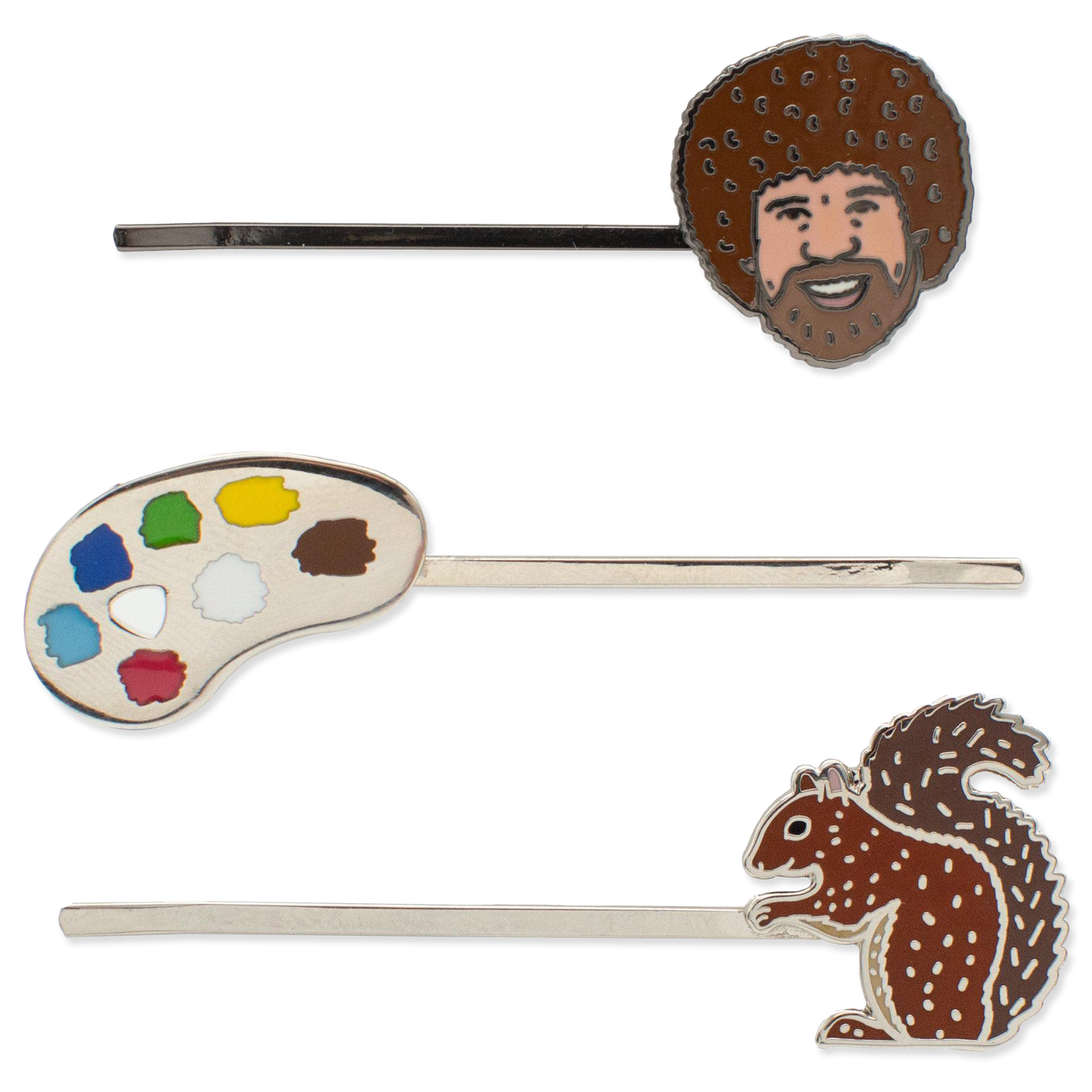 Three hair pins with artistic designs on a white background