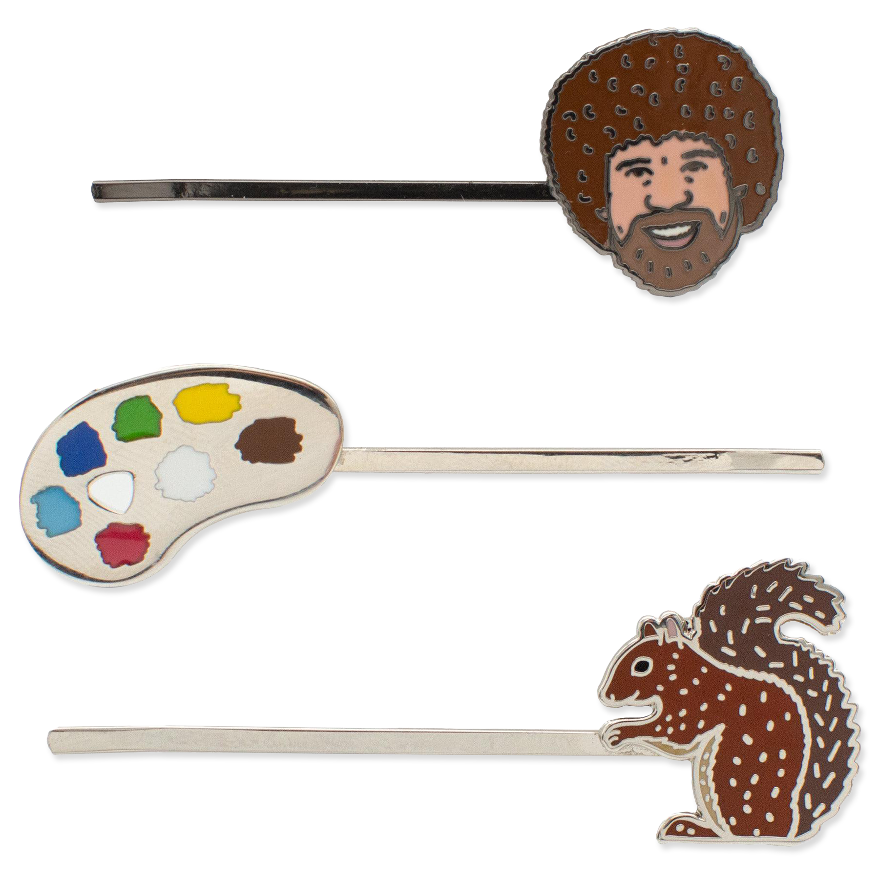Three hair pins with artistic designs on a white background