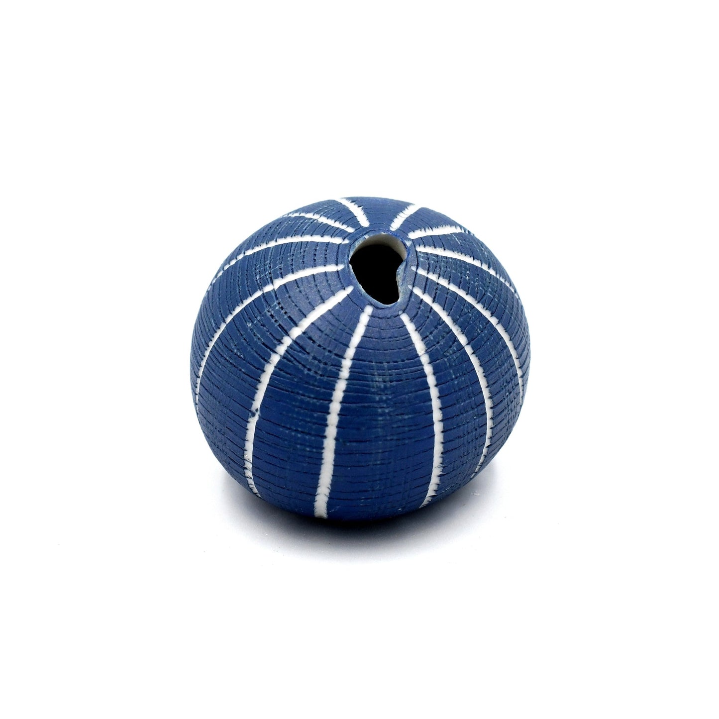 Blue vase with white stripes on a white background