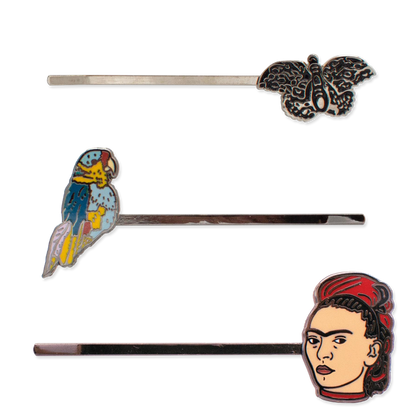 Set of hair pins with parrot, butterfly, and Frida Kahlo designs on a white background