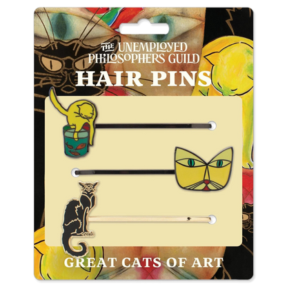 Packaged hair pins with cat designs by The Unemployed Philosophers Guild on a colorful background.