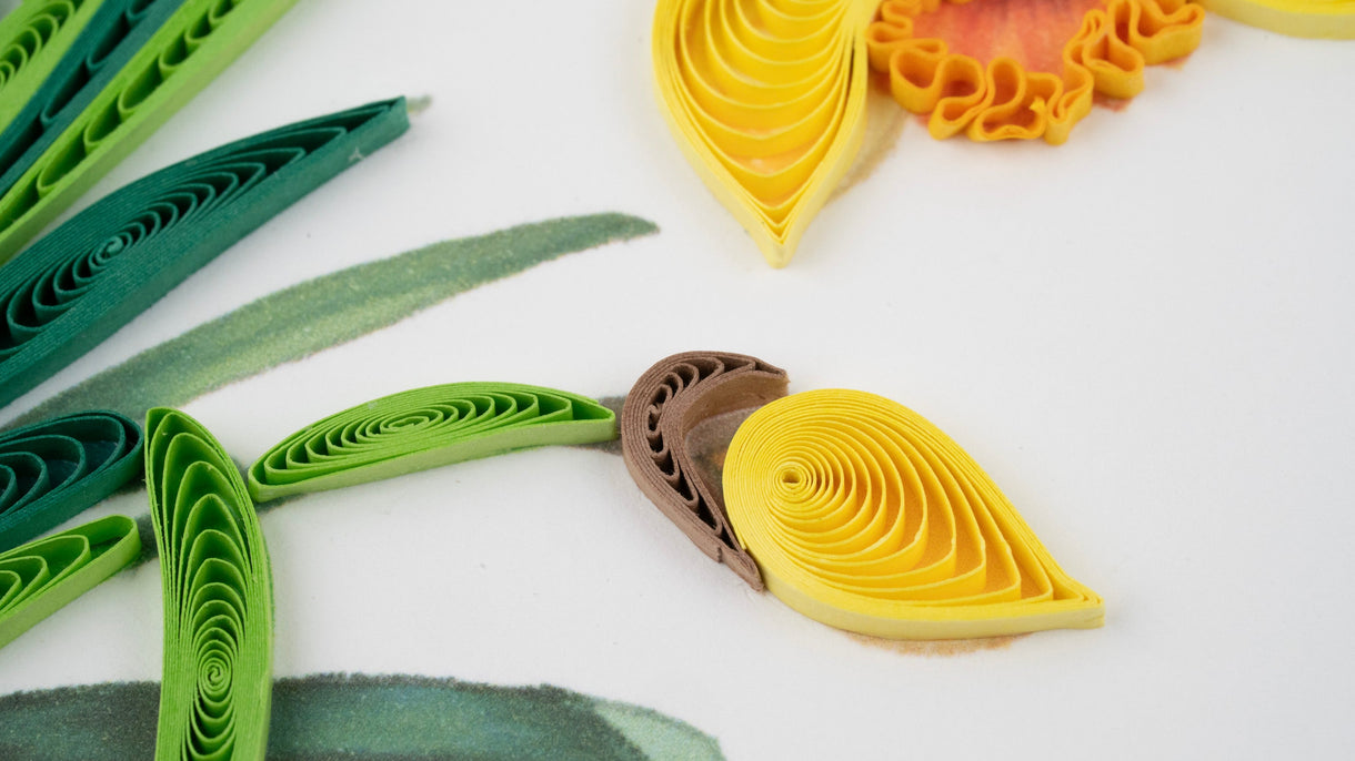 Quilled paper flowers and leaves on a white background