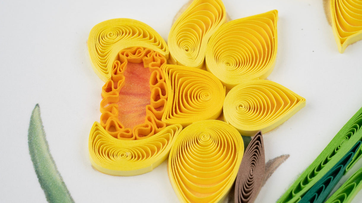 Quilled yellow flower with a white background