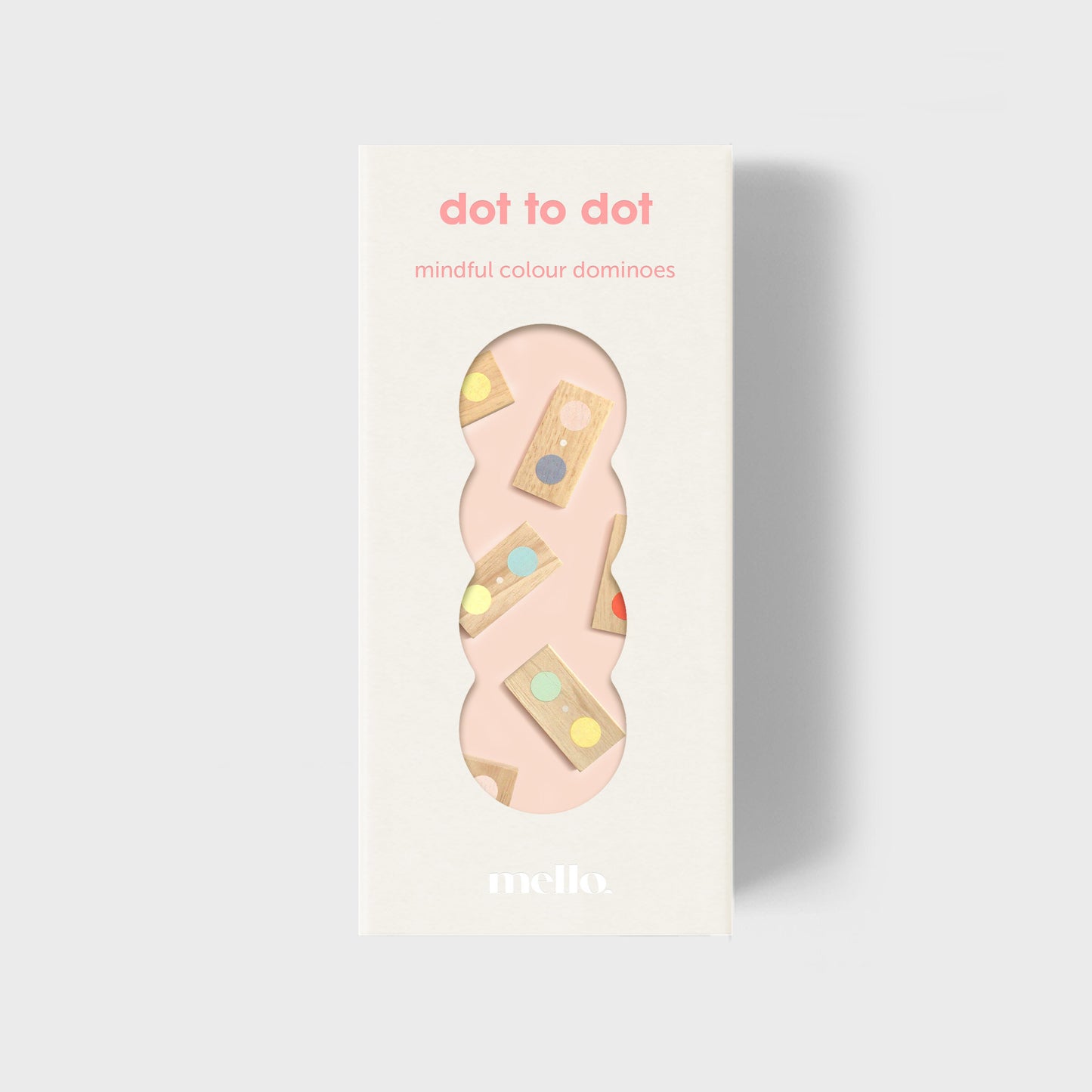 Packaging of 'dot to dot mindful colour dominoes' with a pink domino on a light gray background