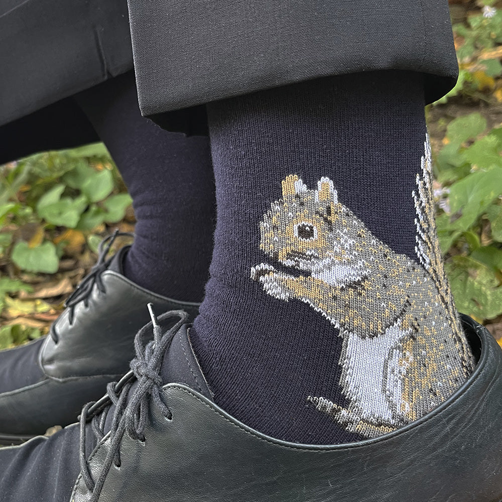 Person wearing socks with a squirrel design outdoors