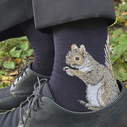 Person wearing socks with a squirrel design outdoors
