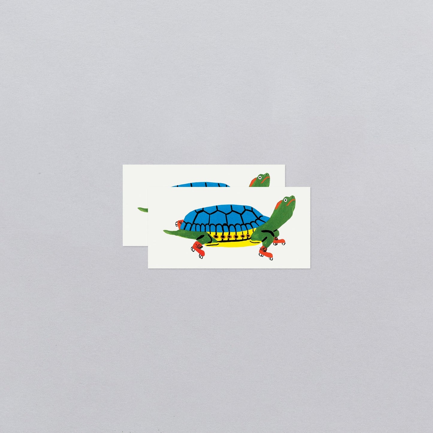 Cartoon turtle with a blue shell on a white card against a gray background