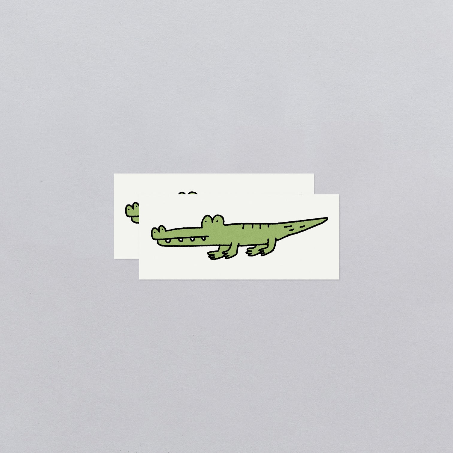 Cartoon alligator temporary tattoos with a gray background