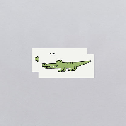 Cartoon alligator temporary tattoos with a gray background